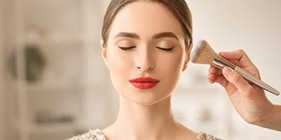 Woman getting makeup applied to her face