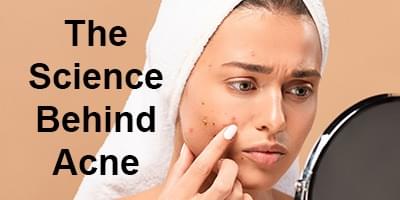 Woman looking at spots on her face with words that read "The Science Behind Acne"
