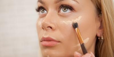 Woman applying foundation