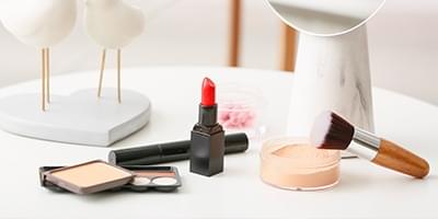 Assorted makeup products like lipstick, foundation, and powders