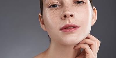 Woman with freckles looking at camera