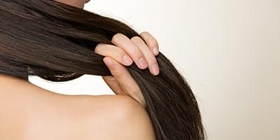 Woman running her hands through her straight hair