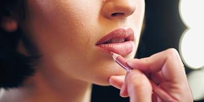 Woman applying lip liner