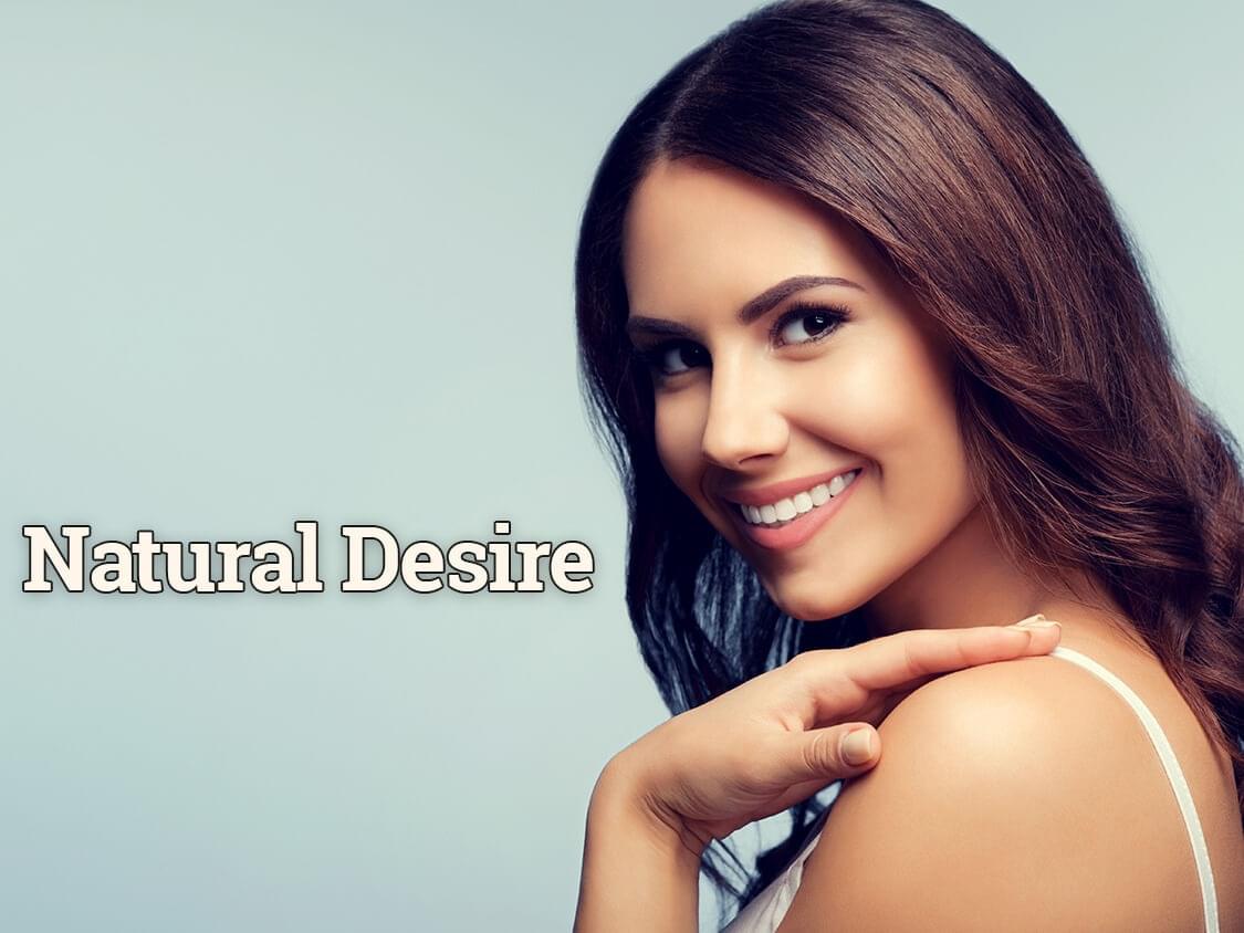 Woman smiling at camera that reads "Natural Desire"